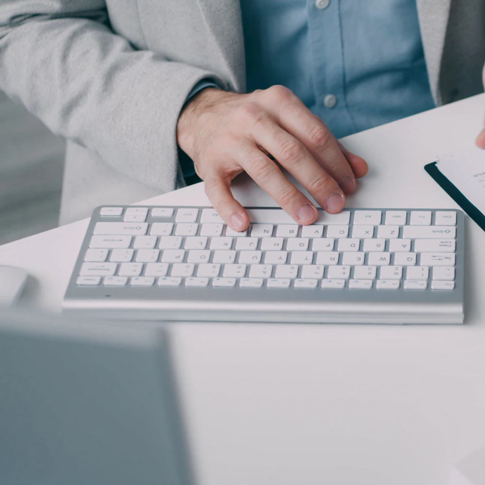 Accountant reviewing printed annual accounts and financial statements at a desk